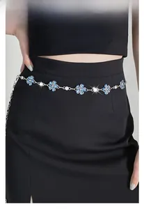 Detail of silver waist chain with blue crystal flowers and rhinestones on black dress