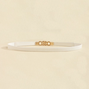 Close-up of white textured belt featuring an interlocking gold metal ring buckle