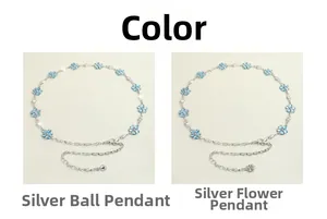 Detail view of silver chain belts with blue crystal flower charms and ball pendants