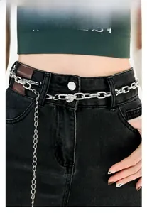 Detail of silver multi-layer metal chain belt on black denim jeans for modern women