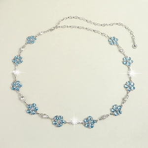 Detailed view of silver chain belt with blue crystal flowers and sparkling rhinestones