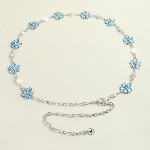 Detailed view of silver chain belt featuring blue five-petal flowers and crystal accents