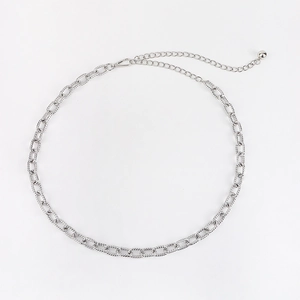 Detailed view of silver metal waist chain featuring twisted oval links and a bead pendant