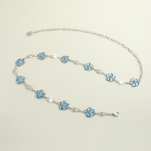 Detail of silver flower waist chain with blue crystals and lobster clasp closure