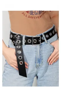 Detail shot of black punk style PU leather belt with silver eyelets and square pin buckle