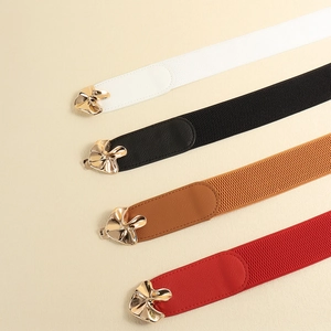 Set of 4 elastic waist belts for women in black, white, brown and red with gold floral buckles