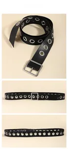 Detail showing soft black leather punk belt with double rows of silver metal eyelets