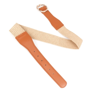 Close-up of beige woven belt featuring a bamboo-style gold metal buckle and leather joint