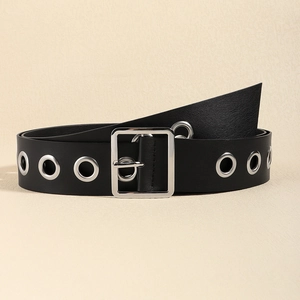 Close-up of black punk waist belt with large silver square buckle and metal eyelet detail