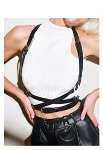 Detail of black leather body harness with silver metal buckles on white top