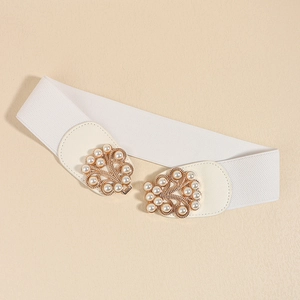 Close-up of elegant wide white elastic belt featuring ornate pearl buckle with gold finish