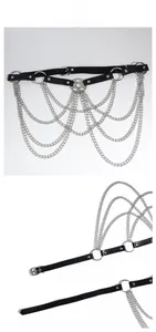 Detail of punk body chain with black leather belt, silver multi-layer metal chains and star charm