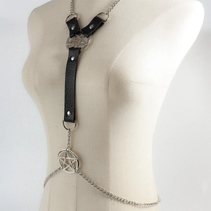 Detail of gothic body chain with leather straps, silver metal rivets and star pendants