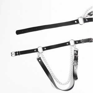 Close-up of punk style black PU leather body chain with silver metal rings and double chains