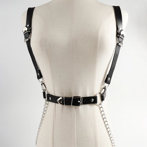 Detail of black PU leather body harness with silver heart studs and hanging chains