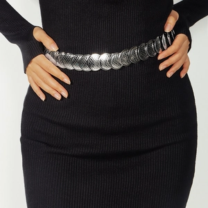 Close-up of textured silver round metal discs linked as a stylish elastic waist belt