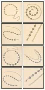 Detail of bohemian waist chains in gold and silver with blue-green floral inlay