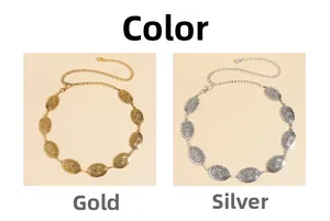 Close-up of gold and silver metal waist chains with sunburst relief and ball pendants
