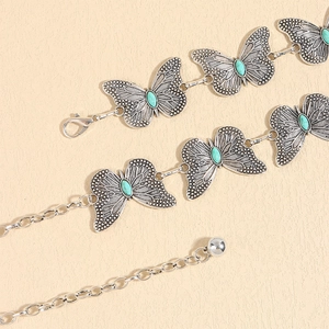 Detail of vintage butterfly waist chain with turquoise stones and adjustable silver links