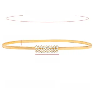 Detail of golden elastic waist chain with three rows of sparkling rhinestones for dresses