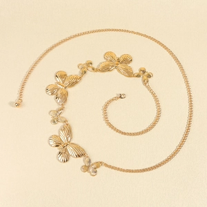 Close-up of gold butterfly waist chain with hollowed texture and lobster clasp