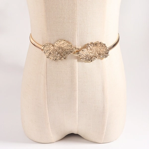 Elegant golden metal spring waist chain featuring detailed leaf buckles for dresses