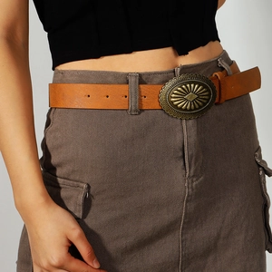Detailed macro of vintage brown leather belt with large antique bronze oval buckle