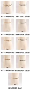 Detail view of various metallic gold and silver spring waist belts for elegant dresses