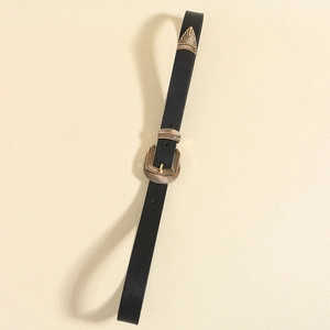 Detail of black belt with vintage gold needle buckle and radial embossed texture patterns