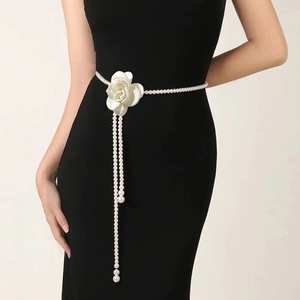 Detailed view of elegant pearl waist chain featuring a white rose flower and tassel drops