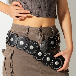 Close-up of vintage wide belt with silver hammered metal discs and boho punk hardware