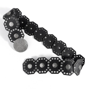 Close-up of vintage punk style wide belt with black octagonal leather tiles and metal ring links