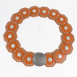 Detail of bohemian waist belt featuring orange leather octagons and hammered silver metal discs