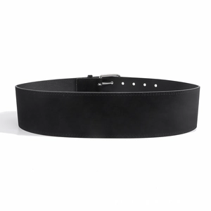 Close-up of wide black velvet waist belt with silver metal square buckle and stitching details