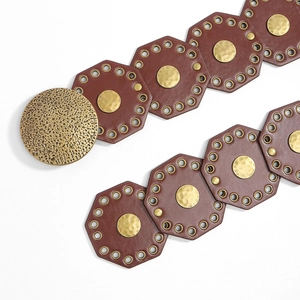 Detail of vintage leather belt with octagonal segments and large textured metal buckle