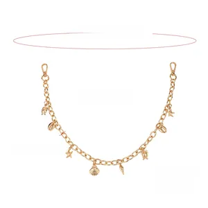 Detail of a golden hip-hop chain with ocean-themed starfish, shell, and turtle charms