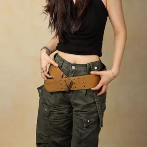 Detail of tan vintage wide belt with double eyelets and large silver square buckle