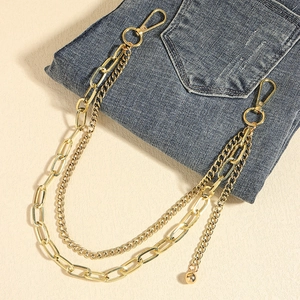 Detail of double-layered gold hip hop waist chain with lobster clasps on denim pants