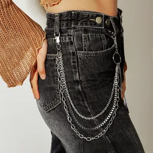 Detailed view of silver triple-layered metal pants chain with punk style on black denim jeans