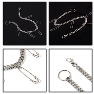 Detail view of silver punk pants chain with safety pins and lobster clasp on metal links