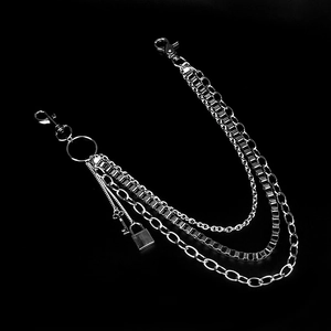 Detail of silver triple-layered punk hip hop chain with key and lock pendants