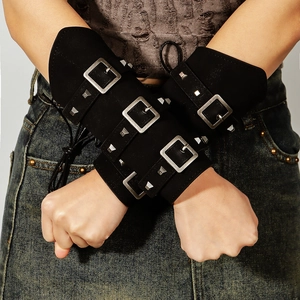 Detail view of retro punk black faux suede bracers with silver buckles and rivets