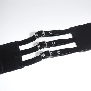 Macro detail of black PU leather corset belt featuring triple silver buckles and eyelets