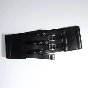 Detail view of the black elastic corset belt showing triple silver buckles and PU leather straps