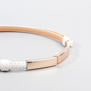 Close-up of white leather belt with polished gold metal buckle and neat stitching