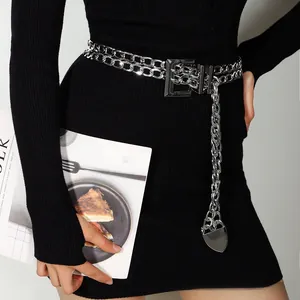 Detail of silver double-layered chain belt with heart pendant on a black dress
