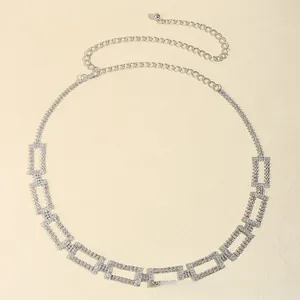Detail view of silver waist chain with rectangular links and sparkling rhinestones