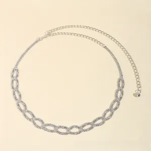 Detailed macro view of silver waist chain belt featuring rhinestone-encrusted oval links