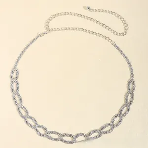 Close-up of elegant silver chain belt with shimmering rhinestones and lobster clasp