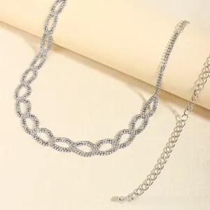 Detail showing elegant silver infinity chain belt with sparkling rhinestones for dresses